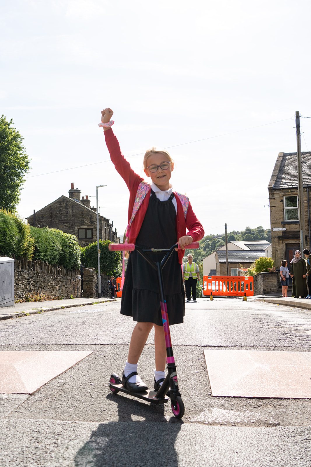 A child scooting to school on a car-free street in Rastrick
